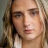 Intimate close-up portrait of a young woman with long blonde hair and natural beauty.